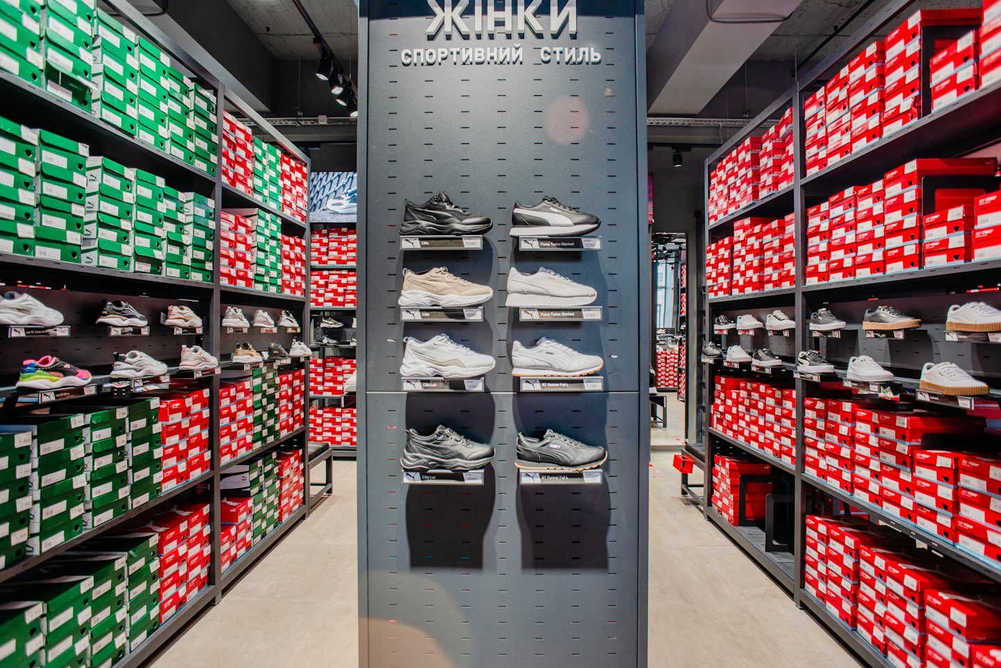 Modern shoe store interior with display wall and shoe boxes.